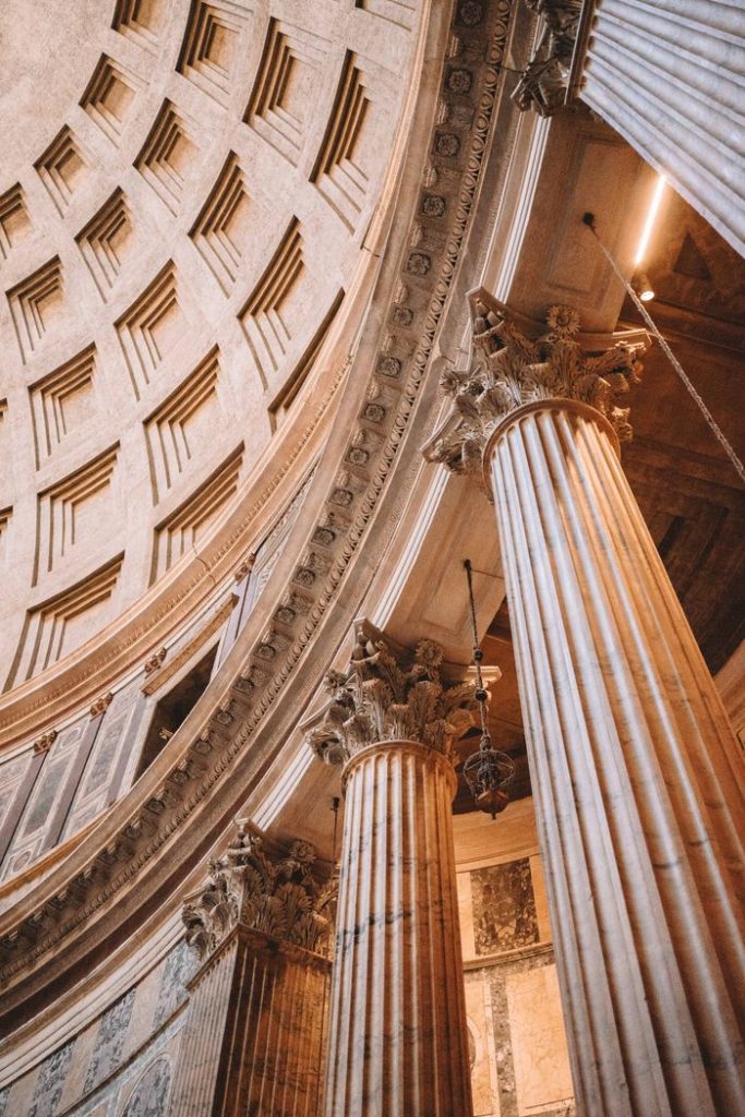 Low angle view of the Pantheon dome and columns in Rome, showcasing Roman architecture.